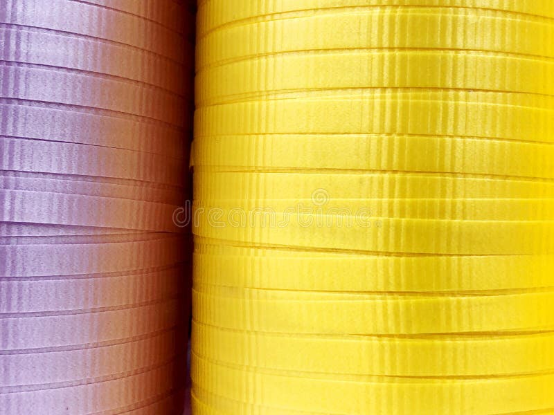 An Assortment of Multicolored Decorative Ribbons Displayed on Rolls on