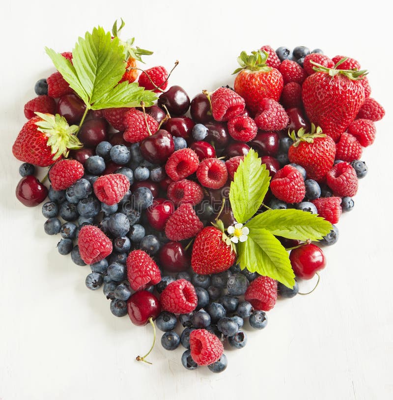 Assortment of summer fresh berries in the shape of heart