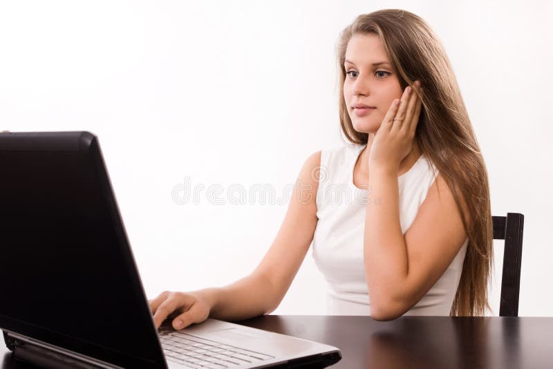 Astonished girl behind a laptop