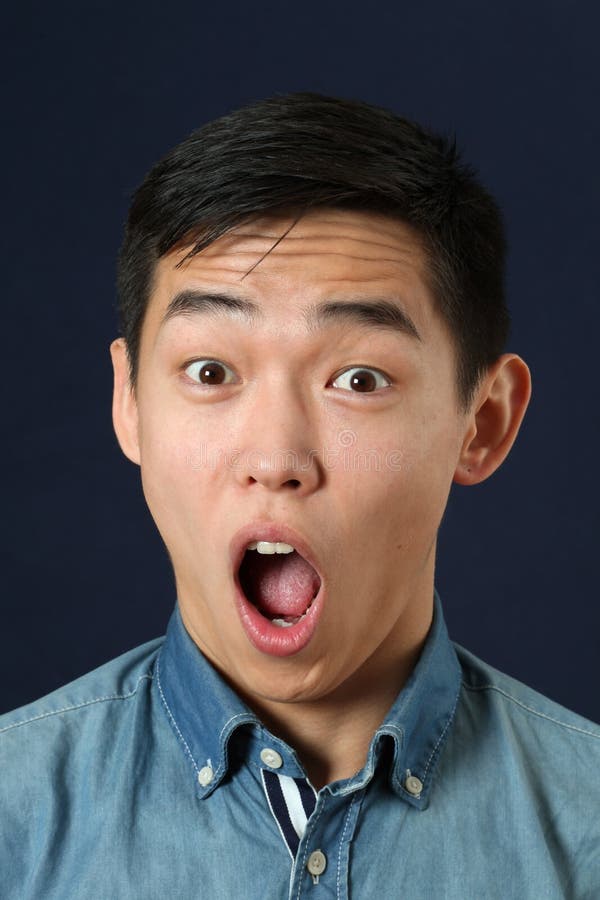 Astonished young Asian man with opened mouth