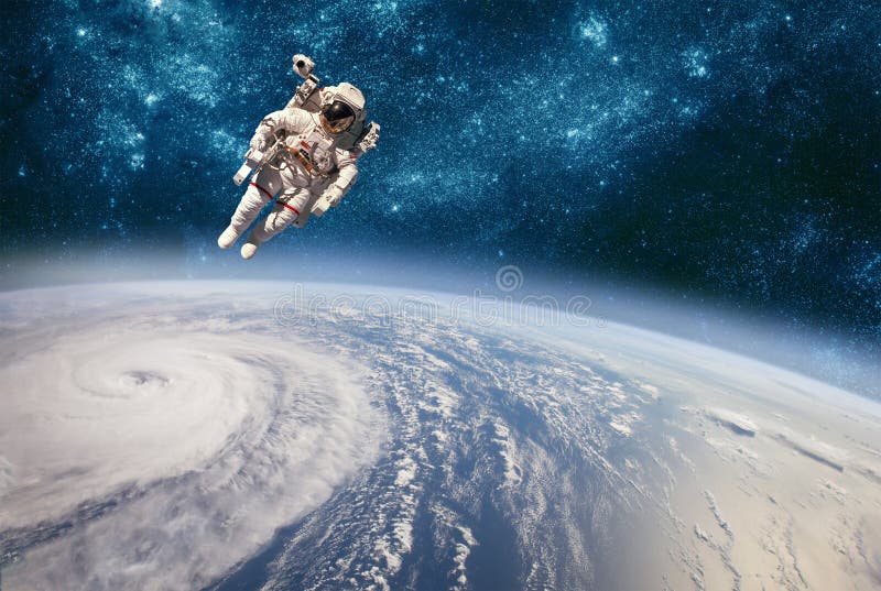 Astronaut in outer space against the backdrop of the planet earth. Typhoon over planet Earth