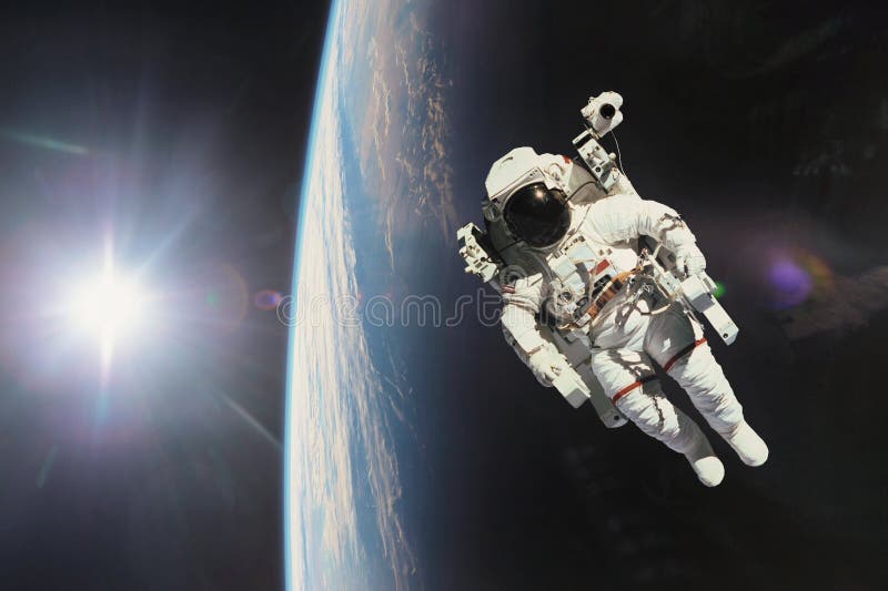 Astronaut in outer space with planet earth as backdrop. Elements stock image