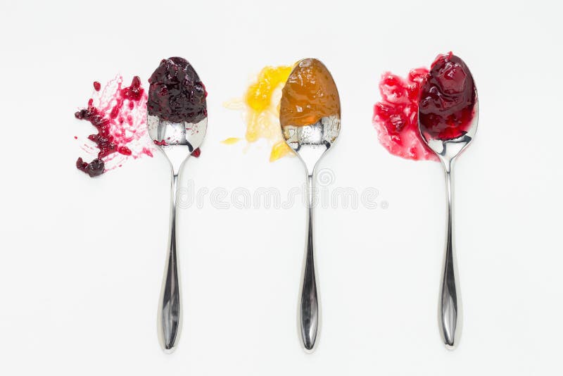 Mixed berry, apricot and sour cherry jam on spoons. Mixed berry, apricot and sour cherry jam on spoons