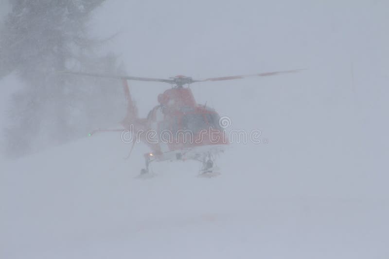 Red Cross Helicopter landing on the snow in St Moritz during the ski world cup. normally it transports injured skiers to the hospitals close by. Red Cross Helicopter landing on the snow in St Moritz during the ski world cup. normally it transports injured skiers to the hospitals close by.