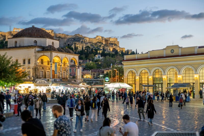 Athens, Attica, Greece - Nov 5, 2020: Monastiraki square at dusk. Tzistarakis old Ottoman Mosque on the left, metro station on the right, Acropolis hill in the background