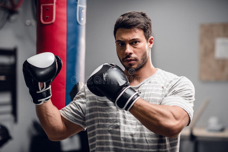 An Athlete Boxer Poses For A Photo Session In The Hall Where He Is 