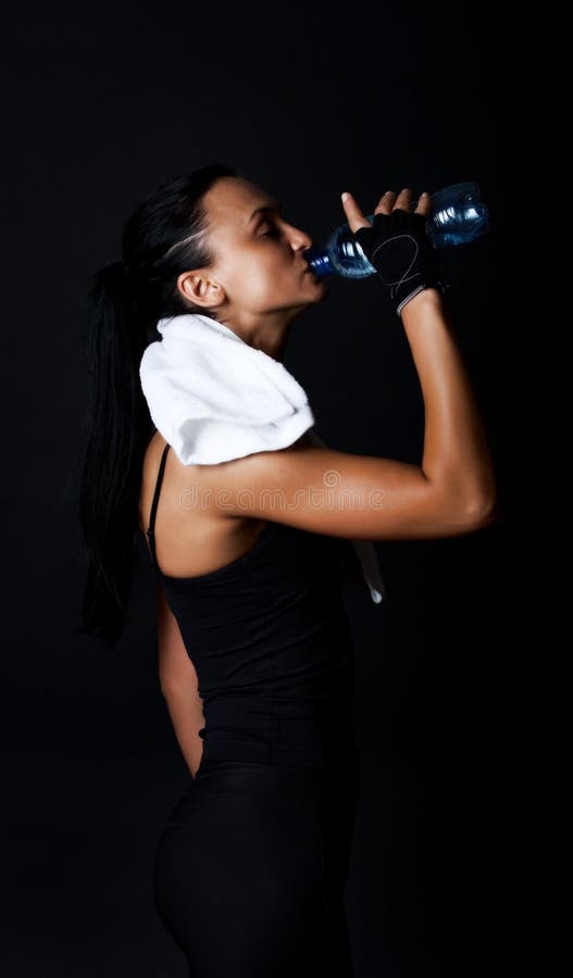 Athlete drinking water during her training