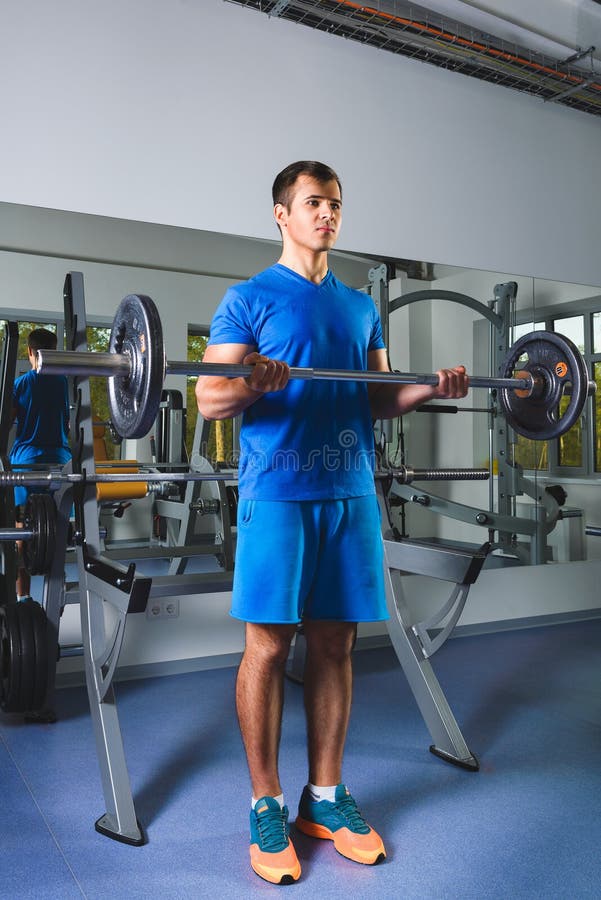 Athlete Muscular Bodybuilder and Personal Trainer in the Gym Training