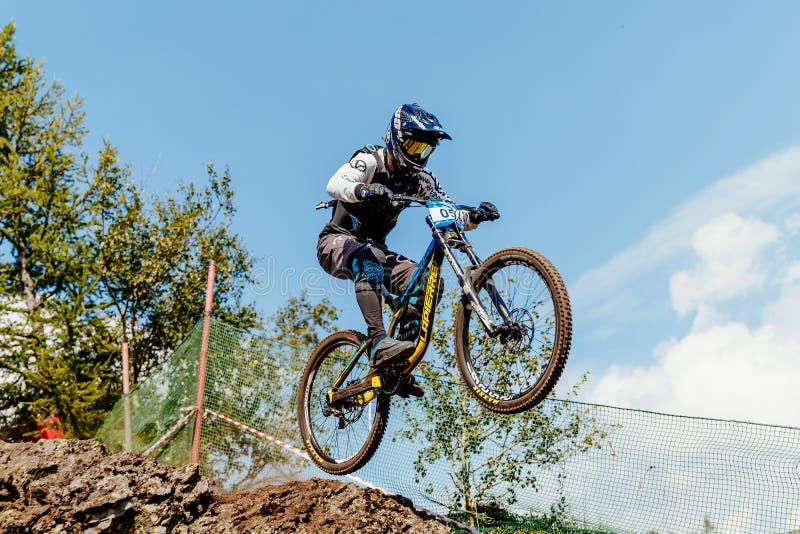 athlete rider on bike gap jump from mountain stock photo athlete rider on bike gap jump from mountain stock photo
