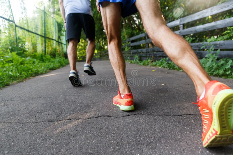 Athletes Jogging in the Park. Legs Closeup Stock Photo - Image of ...