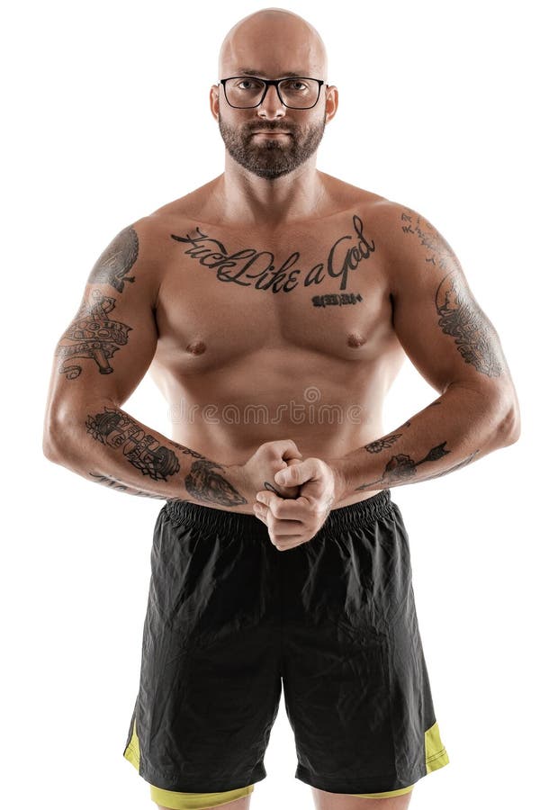 Athletic bald, tattooed man in black shorts is posing isolated on white background. Close-up portrait. royalty free stock images