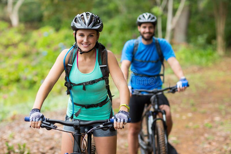 Smiling athletic couple cycling in forest. Adventurer adventure stock images, royalty-free photos and pictures