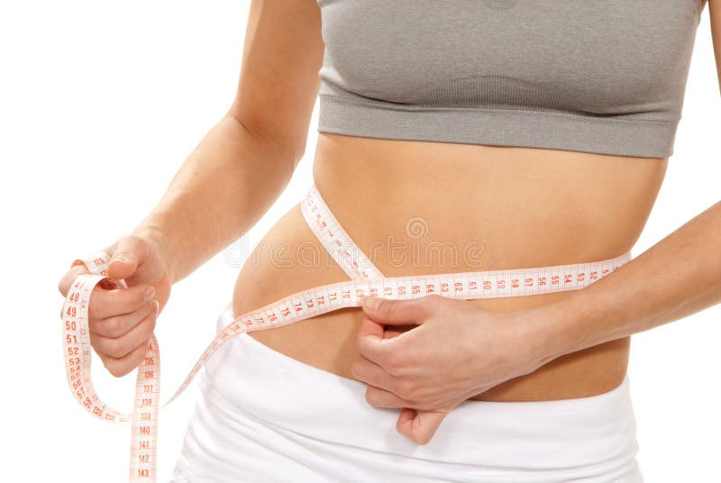 Athletic fit slim female measuring her waist