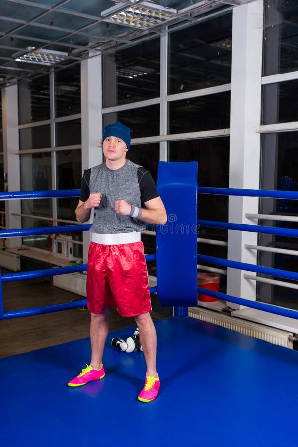 Athletic Male Boxer Standing in a Regular Boxing Ring Stock Photo