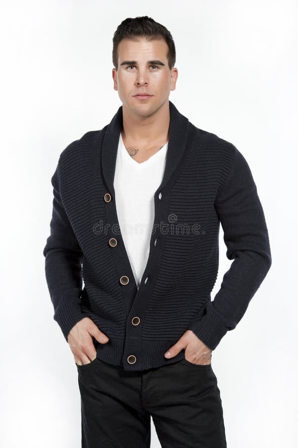 Athletic Male in Sweater on White. Good looking caucasian athletic male model wearing a trendy buttown down sweater, black pants and a white t-shirt posing in a royalty free stock photo Athletic Male in Sweater on White. Good looking caucasian athletic male model wearing a trendy buttown down sweater, black pants and a white t-shirt posing in a royalty free stock photo