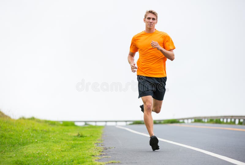 Athletic man running jogging outside