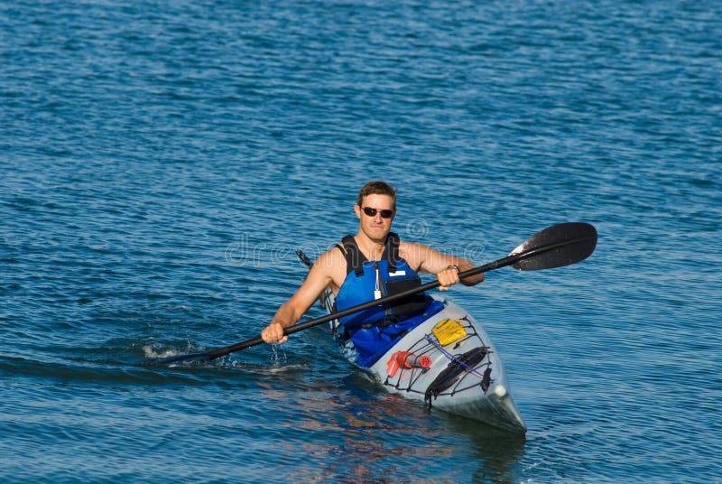 Athletic man in sea kayak