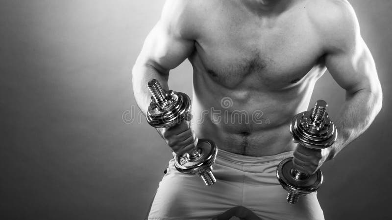 Athletic man working with heavy dumbbells