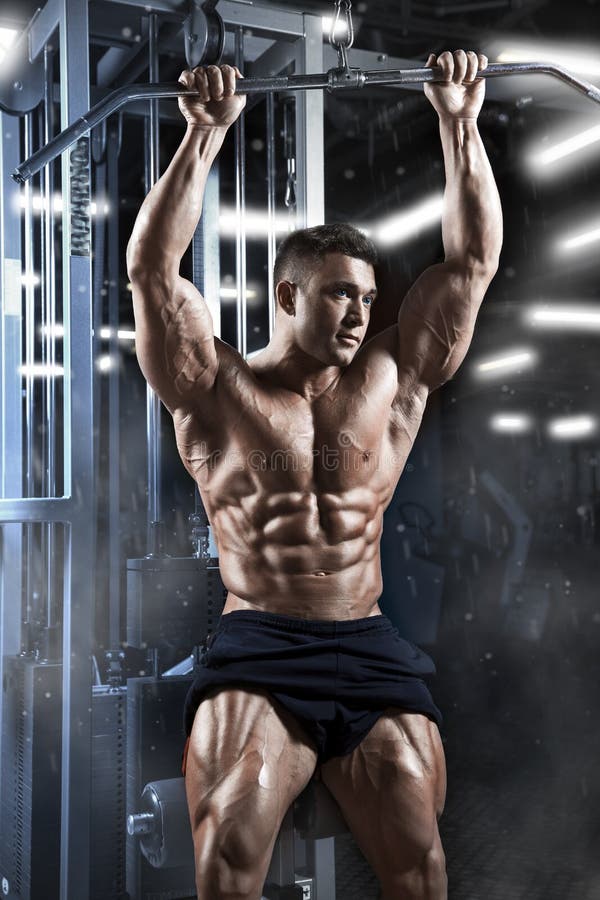 Athletic muscular guy prepare to do exercises with athletic trainer in a gym stock photos Athletic muscular guy prepare to do exercises with athletic trainer in a gym stock photos