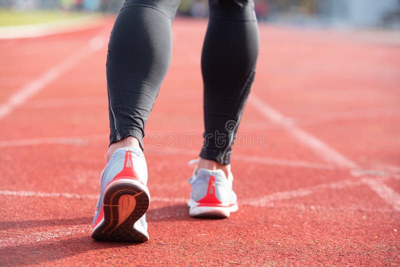 Athletic Person on Running Track Getting Ready To Start Run, Back View