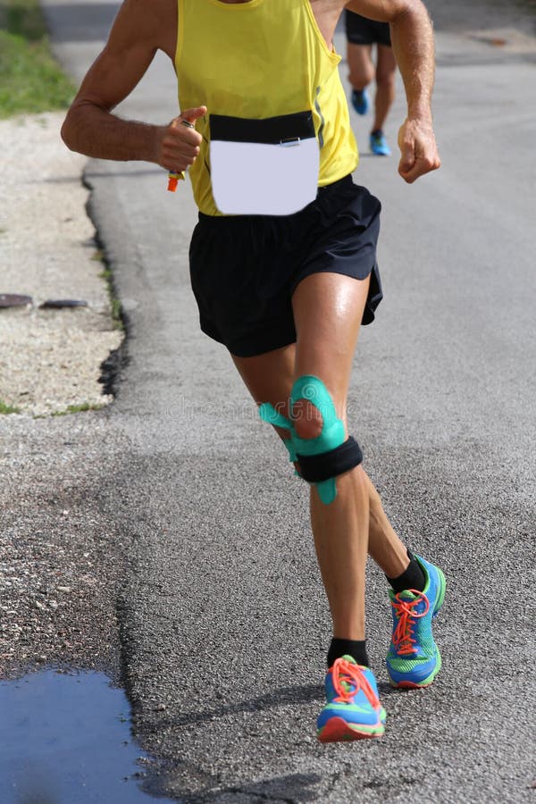 Athletic Runner with Elastic Band at the Knee Running Fast Stock Image