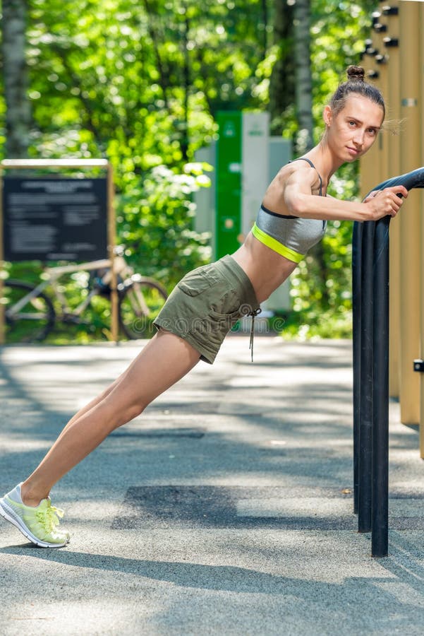 athletic trainer doing press exercises on the sports ground royalty free stock images athletic trainer doing press exercises on the sports ground royalty free stock images