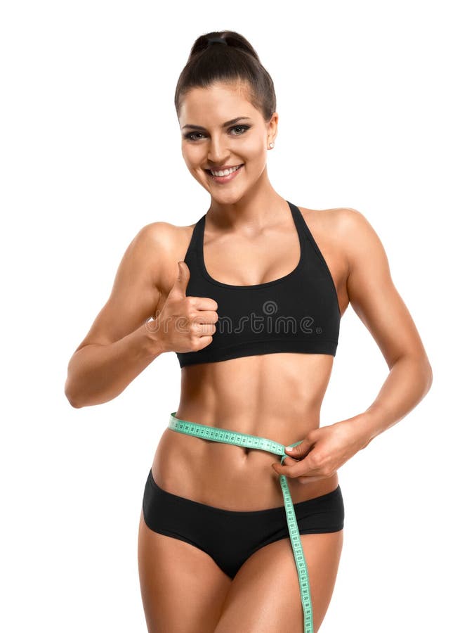 Athletic woman measuring her waist and showing thumb up isolate