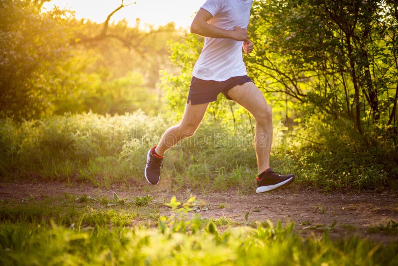 Athletic young man running in nature