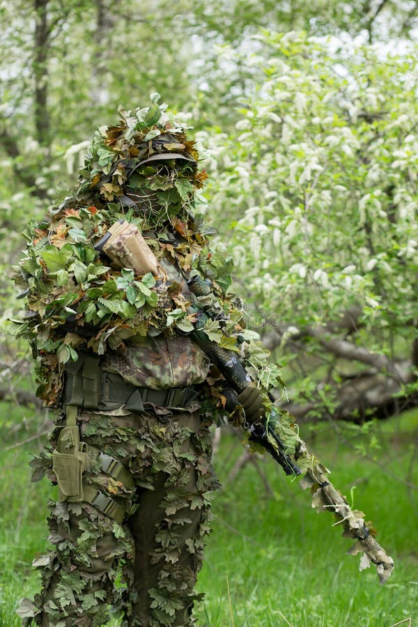 Atirador furtivo camuflado na floresta em emboscada. militar apontando uma  arma, um rifle para o inimigo na natureza. exército, airsoft, hobby,  conceito de jogo