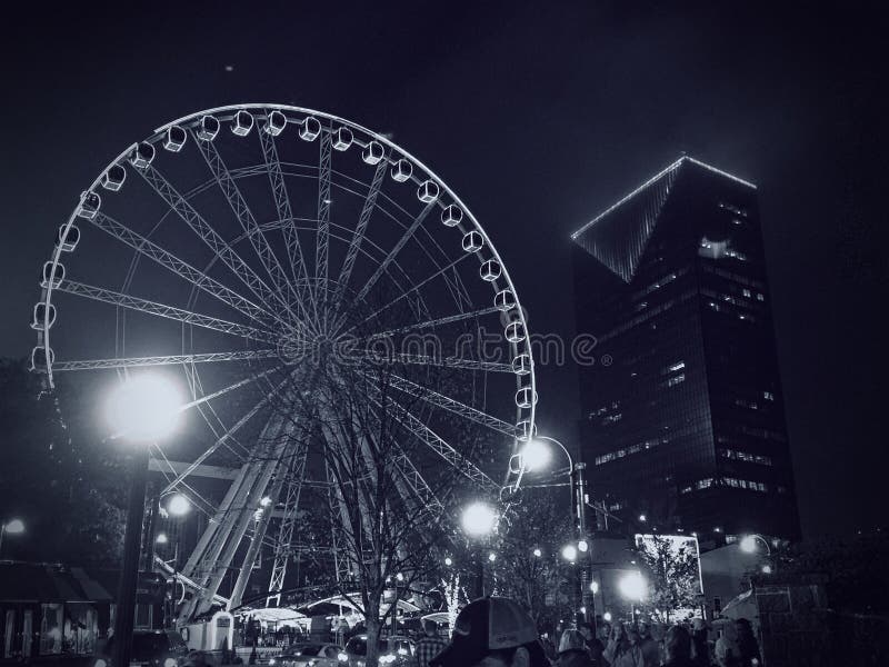 Black and white image of a giant ferris wheel at night located next to Centennial Olympic Park in downtown Atlanta, Georgia. Black and white image of a giant ferris wheel at night located next to Centennial Olympic Park in downtown Atlanta, Georgia.