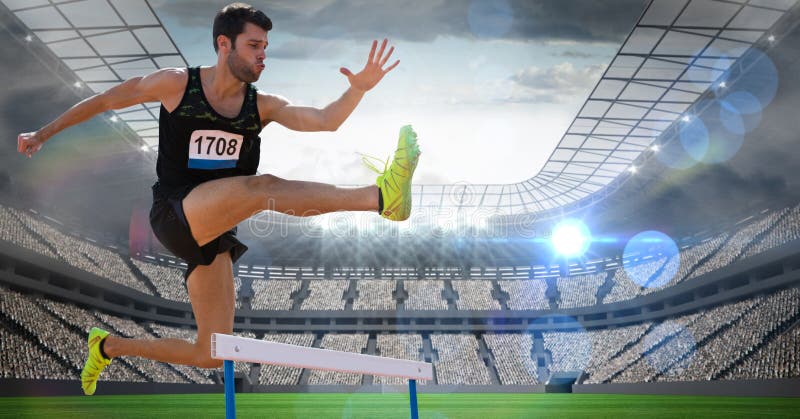 Atleta de sexo masculino que salta sobre el obstáculo en estadio imagen de archivo Atleta de sexo masculino que salta sobre el obstáculo en estadio imagen de archivo