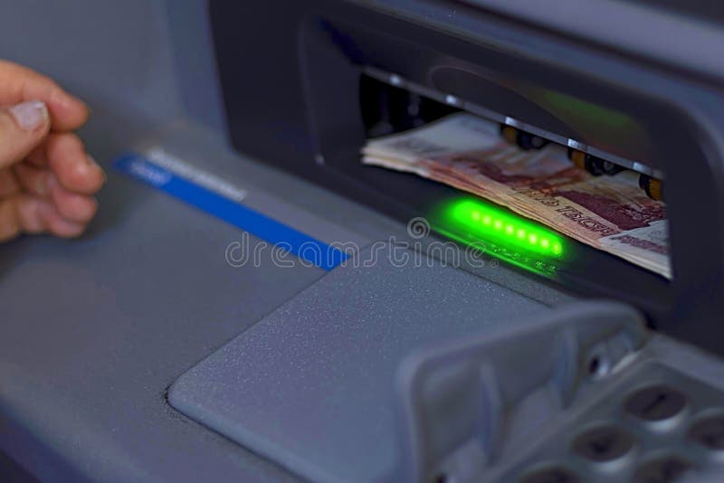 A Bundle of Paper Money is Inserted into the Open ATM Receiver Stock
