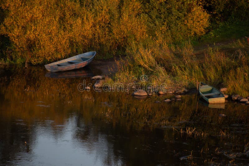 Atmospheric photograph of abandoned boats on the river bank