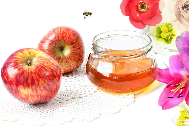 Apples, honey in the glass pot and bee flying. Composition with colorful soft balmy flowers. White background. Apples, honey in the glass pot and bee flying. Composition with colorful soft balmy flowers. White background