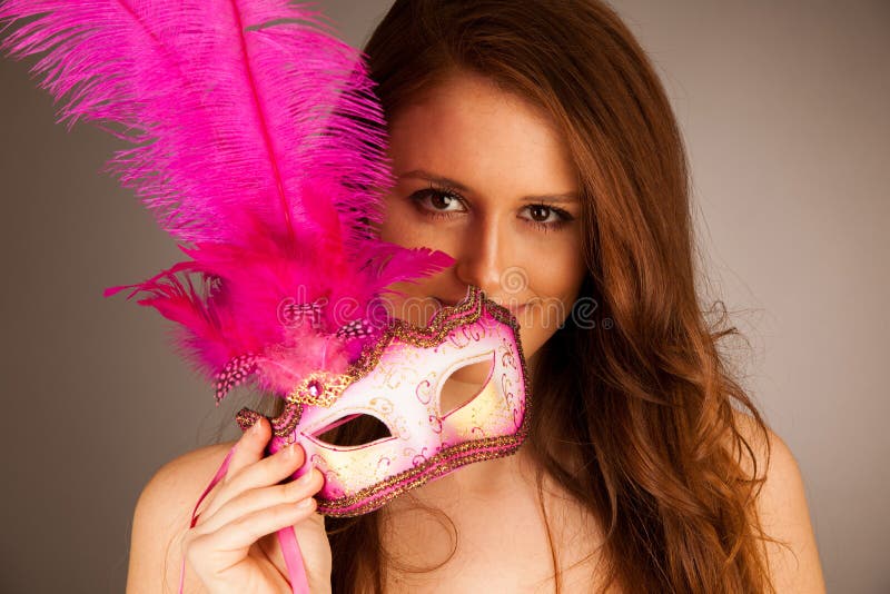 Atractive young woman with venice mask studio portrait stock image Atractive young woman with venice mask studio portrait stock image
