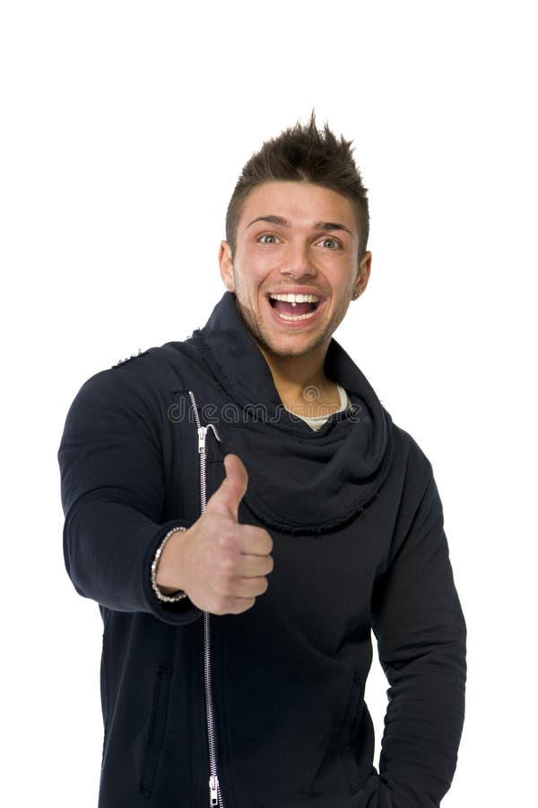 Atrakcyjny szcz??liwy m?odego cz?owieka ono u?miecha si?, robi kciukowi up podpisuje obraz royalty free Atrakcyjny szcz??liwy m?odego cz?owieka ono u?miecha si?, robi kciukowi up podpisuje obraz royalty free