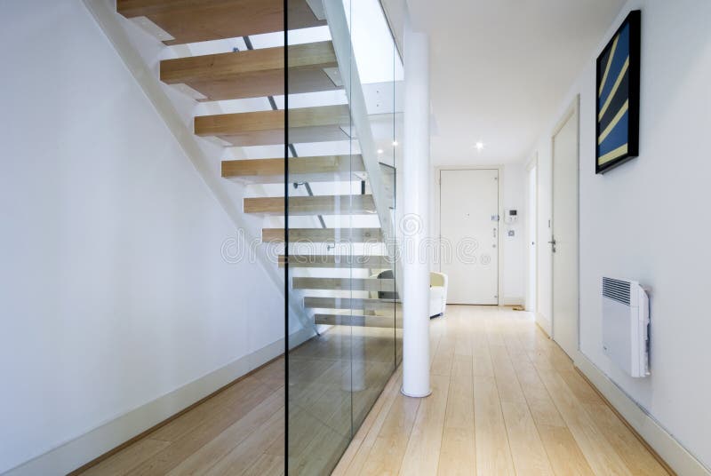 modern entrance hall with staircase and glass wall. modern entrance hall with staircase and glass wall