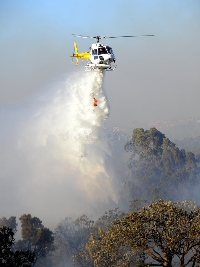 Helicpter dropping water on a bushfire. North Beach, Perth, Western Australia. Helicpter dropping water on a bushfire. North Beach, Perth, Western Australia.