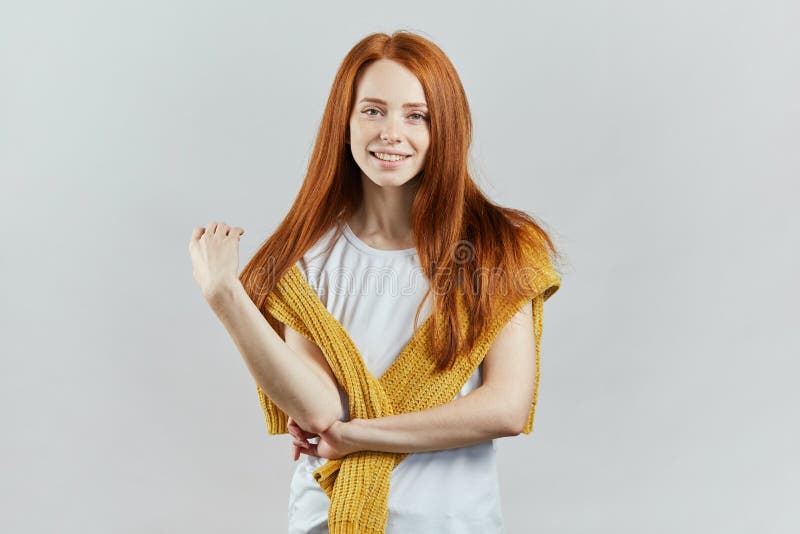 Attarctive good looking girl with long red hair and beautiful green eyes