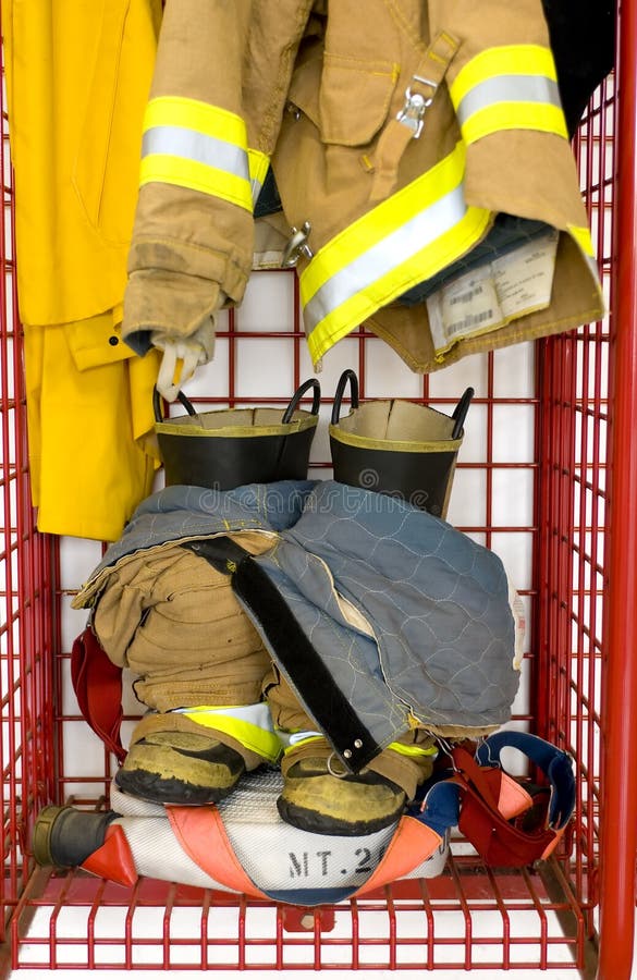 Fireman clothes are prepared for quick use in a locker. Fireman clothes are prepared for quick use in a locker
