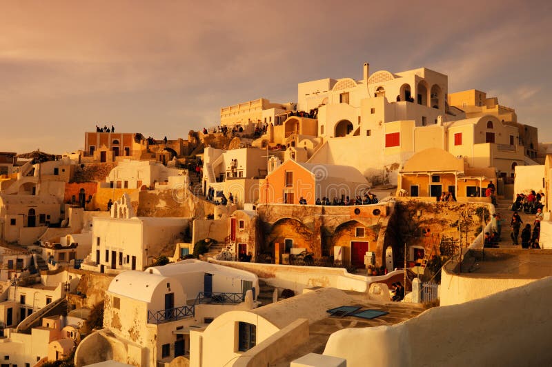 Image shows the traditional village of Oia, on the Greek island of Santorini with hundreds of tourists waiting for one of its famous sunsets. Image shows the traditional village of Oia, on the Greek island of Santorini with hundreds of tourists waiting for one of its famous sunsets