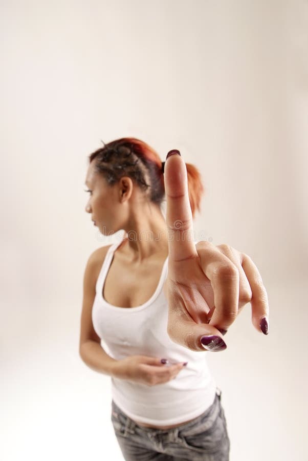 Young woman holding up her index finger. Young woman holding up her index finger