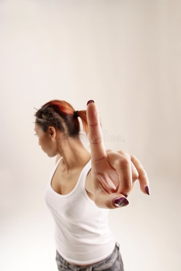 Young woman holding up her index finger. Young woman holding up her index finger