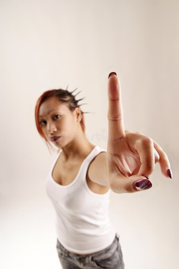 Young woman holding up her index finger. Young woman holding up her index finger