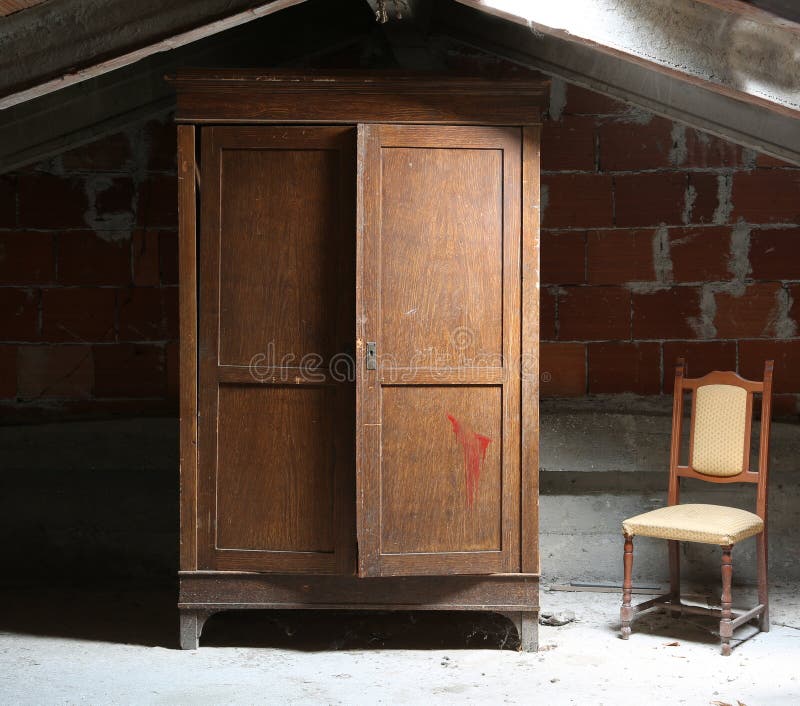 attic of the house with a wooden wardrobe and an old ramshackle chair