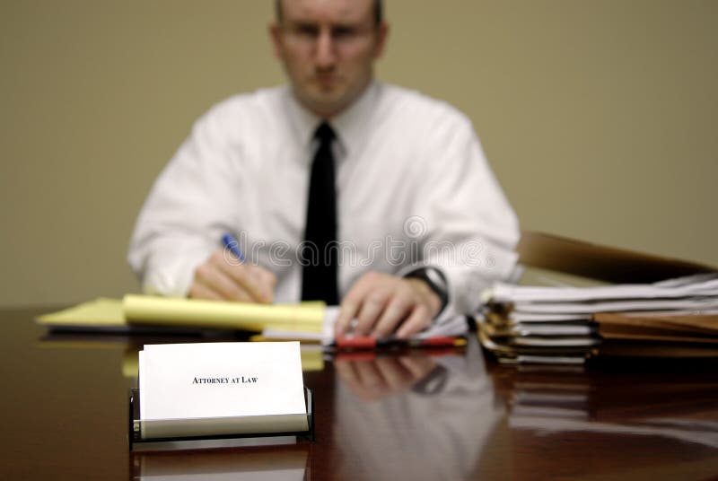 Attorney at Law sitting at desk holding pen with files. Negotiating table stock images, royalty-free photos and pictures