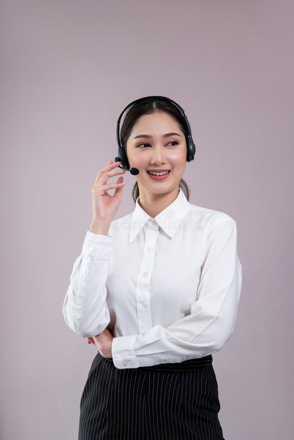 Attractive Asian operator with formal suit and headset. Enthusiastic stock photography