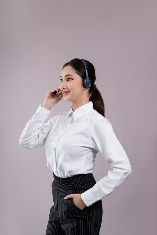 Attractive Asian operator with formal suit and headset. Enthusiastic royalty free stock photography