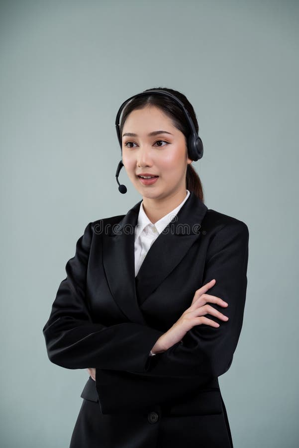 Attractive Asian operator with formal suit and headset. Enthusiastic royalty free stock images