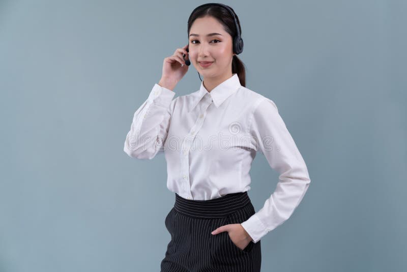 Attractive Asian operator with formal suit and headset. Enthusiastic royalty free stock photo